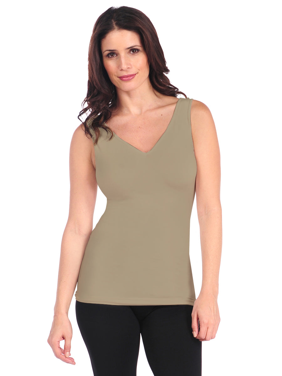 Woman wearing a beige tank top on a white background
